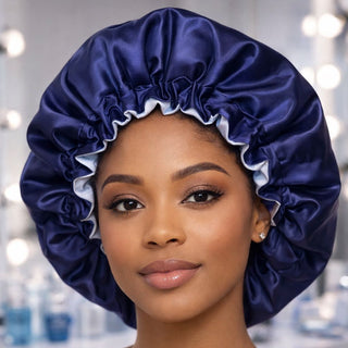 Woman wearing a navy satin bonnet in a blurred bathroom setting