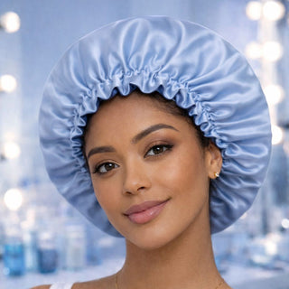 Woman wearing a blue satin bonnet against a blurred background